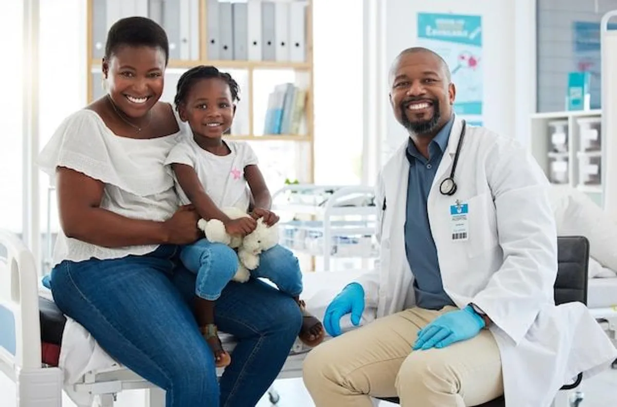 Family doctor consulting with parents and child